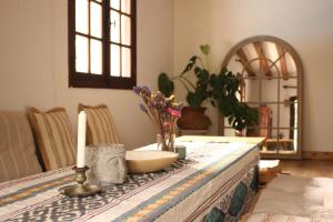 a table with a candle and flowers on it at Yacumama Guesthouse in Soorts-Hossegor +42 photos