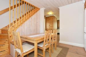a dining room with a wooden table and chairs at Gunnarsgården 36B in Sälen