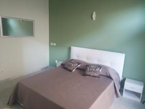 a bedroom with a bed with two pillows on it at Eden Borbonico in Caserta