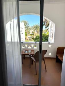 a room with a table and a chair and a window at Oasis Domina Coral Bay in Sharm El Sheikh