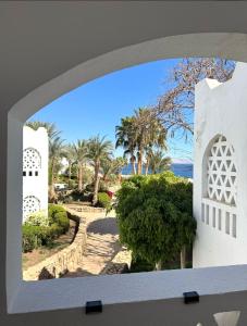 a view of the beach through an archway at Oasis Domina Coral Bay in Sharm El Sheikh