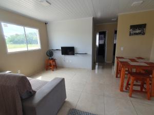 a living room with a couch and a table at Casa de locação in Goiana