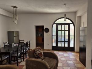a living room with a table and a dining room at Stone house Pietro in Pakoštane
