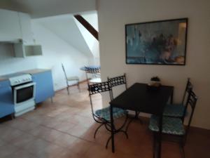 a kitchen and dining room with a table and chairs at Levné a útulné prostředí in Řepiště