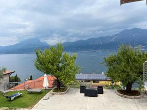 a house with a view of the water and mountains at Villa Teresa.. appartamento “Casa Marta” in Brenzone sul Garda