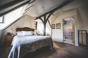 a bedroom with a large bed and a attic at Jeakes House in Rye