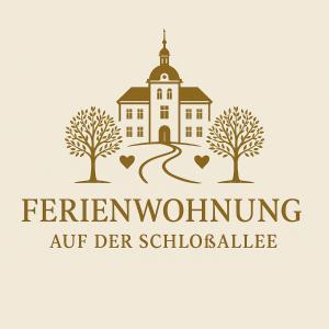 a building with trees and a church logo at Ferienwohnung auf der Schlossallee in Niederwiesa