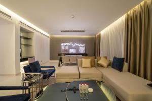 a living room with a large couch and a table at DAMAC Royal Two Bedroom Apartment Al Olaya in Riyadh