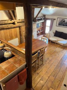 a kitchen and living room with a wooden floor at La Cerveyrette in Cervières