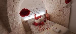 a room with a table with red candles and a wall at Pampa Puglia B&B in Turi +15 photos