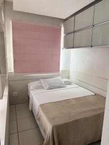 a bedroom with a large bed with a pink window at Apt Chique 1 qto - Aguas Claras in Brasilia +48 photos