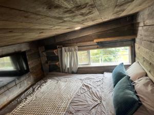 a bedroom with a bed in a room with a window at Rustic Guesthouse in Sayward