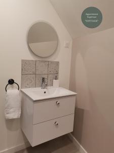a white bathroom with a sink and a mirror at Les Bras de Morphée in Avize +31 photos