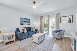 a living room with a blue couch and chairs at Lakefront Condo w Huge Waterfront Pool Hot Tub in North Myrtle Beach