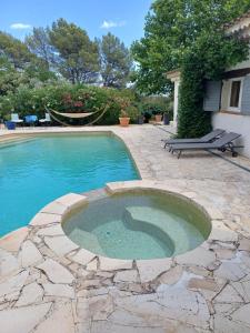 a swimming pool in a yard with a stone patio at Le Mazet du Lapin Rouge in Figanières +10 photos