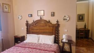 a bedroom with a large wooden bed with white pillows at Casa palaciega Doña Leocadia in Viana