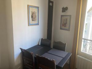 a dining room with a table and chairs and a window at Lovely Paris appartment in Paris +5 photos