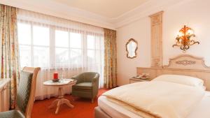 Rúm í herbergi á Superior Hotel Tirolerhof - Zell am See
