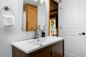 a bathroom with a sink and a mirror at "Cabin Fever" on Arbutus Lake in Traverse City +36 photos