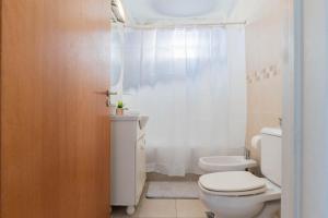 a white bathroom with a toilet and a shower at Fliphaus Ravignani 1200 - Lux 1 Bd Pool Palermo Hollywood in Buenos Aires