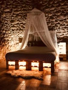 a bed in a room with a mosquito net at La Grotta in Pastrengo