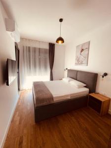 a bedroom with a large bed in a room at Apartments Buongiorno in Ulcinj