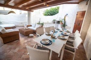 a patio with a white table and chairs at VILLINO DOLCE VITA - a 40 mt dal mare in LIDO DI ENEA - Ombrellone in spiaggia privata in Terracina