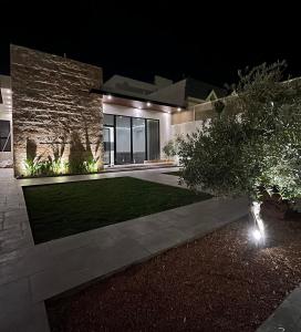 a house at night with a lawn in front of it at فيلا سورا 2 in Buraydah
