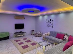 a living room with a couch and a tv at Can’s Homes in Kuşadası