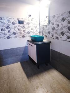 a bathroom with a blue sink on top of a vanity at 2 Bedroom Private Villa near the beach in Alleppey +20 photos