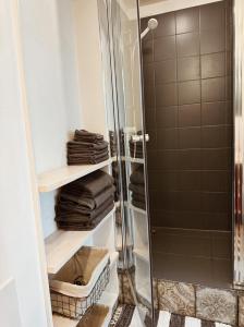 a bathroom with a shower and some towels at Cardinalis house in Pāvilosta +61 photos
