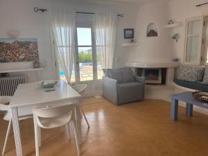 a living room with a table and a chair and a couch at Simos suites in Elafonisos