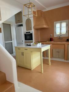 a kitchen with a table in the middle of it at Simos suites in Elafonisos