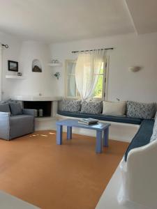 a living room with a blue table and a couch at Simos suites in Elafonisos