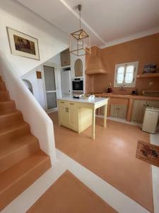 a kitchen with a staircase and a white table at Simos suites in Elafonisos