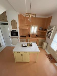 a kitchen with a yellow island in the middle of it at Simos suites in Elafonisos