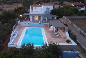 an aerial view of a house with a swimming pool at Simos suites in Elafonisos