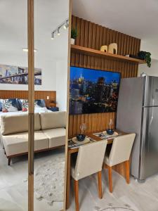 a kitchen with a couch and a table and a refrigerator at Studio with a wonderful view! in São Paulo