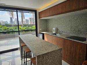 a kitchen with a counter and a large window at Studio with a wonderful view! in São Paulo