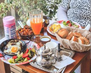 a table with plates of breakfast food and a drink at Riad Dar Salam in Agadir