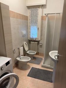 a bathroom with a toilet and a sink and a shower at Casa Clube Mantova in Mantova +18 photos