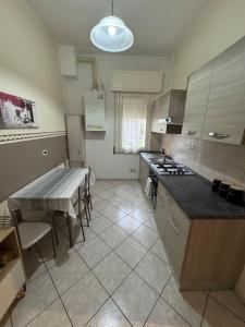 a kitchen with a table and a counter top at Casa Clube Mantova in Mantova