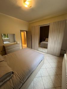 a bedroom with a large bed and a mirror at Casa Clube Mantova in Mantova