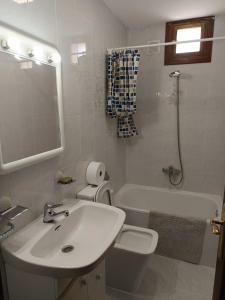 a bathroom with a sink and a toilet and a mirror at B&B Santiago de Redecilla del camino in Redecilla del Camino