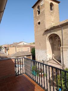 a balcony of a building with a clock tower at B&B Santiago de Redecilla del camino in Redecilla del Camino