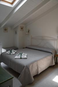 a bedroom with a large bed with towels on it at Casa Viola Bed and Breakfast Dimora di campagna in Calice Ligure