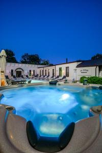 a large swimming pool in a resort at night at La Conac Resort in Hulubeşti
