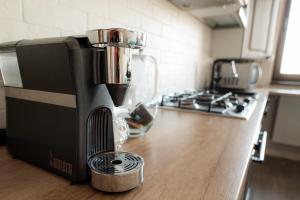 a black coffee maker sitting on a counter in a kitchen at Silver Apartments near Airport and Iulius Mall in Iaşi