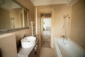 a bathroom with a sink and a tub and a mirror at Silver Apartments near Airport and Iulius Mall in Iaşi +27 photos