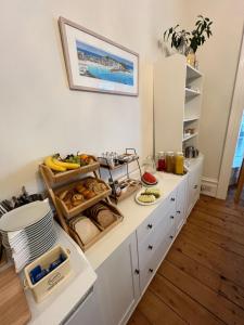 a kitchen with a white counter with food on it at The Tremont in Penzance